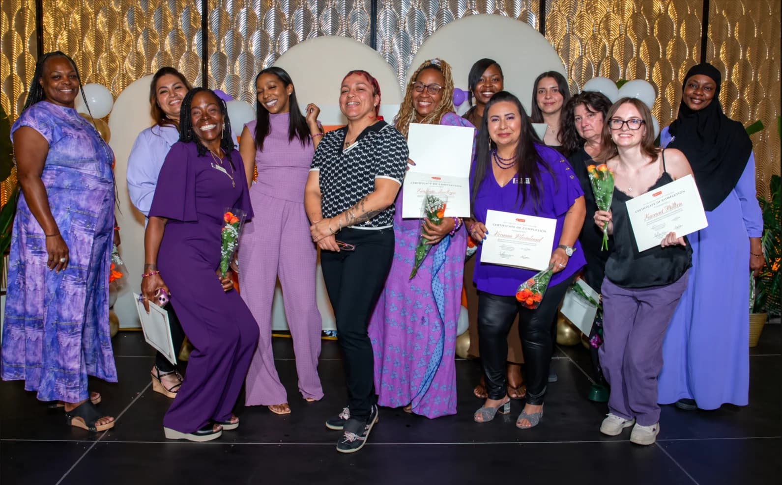 A group holding certificates at a celebration.